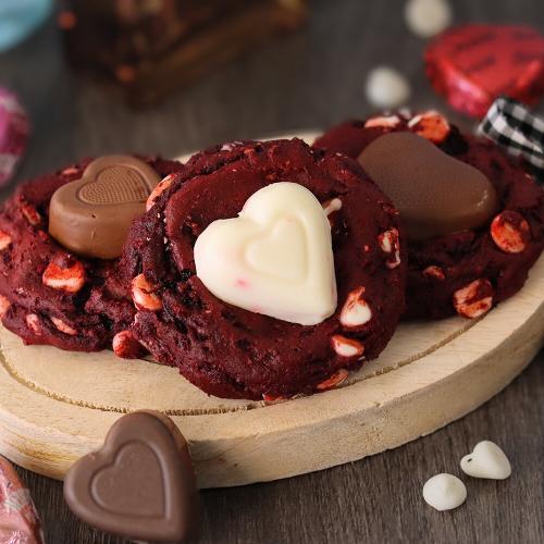 A selection of Red Velvet Sweetheart Cookies on a small wooden board