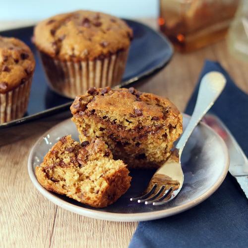 Chocolate Banana Peanut Butter Muffins, one broken open on a plate
