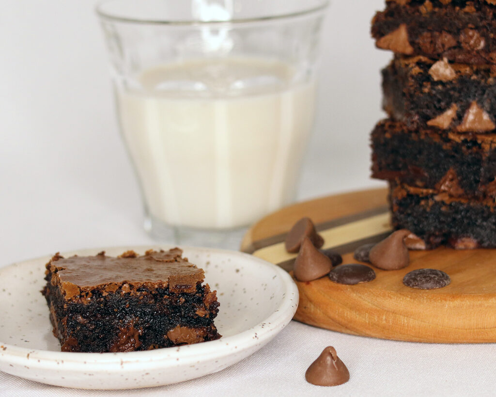 Fudgy Cocoa Brownies, plated with a glass of milk