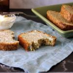 A buttered slice of mom's zucchini bread on a linen napkin