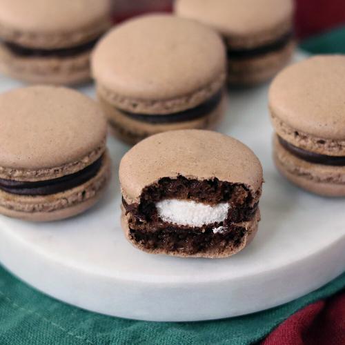 Hot Cocoa Macarons on a snowman serving board.