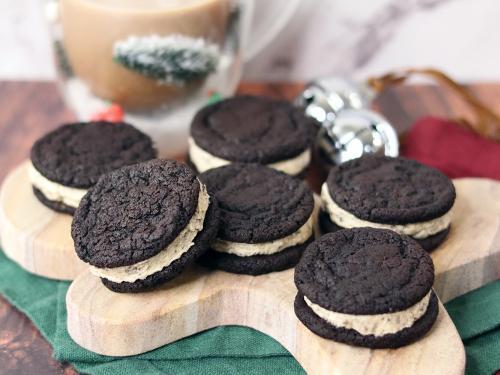 Cookies and Cream Cookie Dough Brownie Sandwiches arranged on a gingerbread man serving board