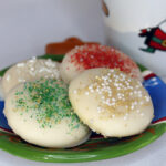 Sugar Cookies on a Christmas plate with a Christmas mug