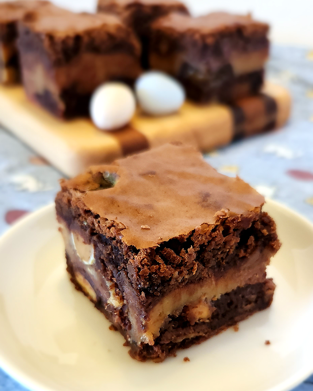 Easter Candy Brownie on a plate, more on a serving board in the background