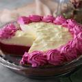 Prickly Pear Lemonade Pie with one slice cut showing the interior of the pie.