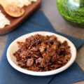 Chocolate Coconut Chips in a small bowl on a blue napkin