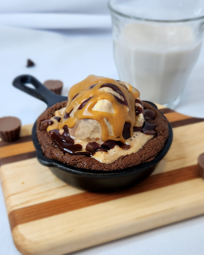 Double Chocolate Chip Cookies for Two skillet preparation with ice cream and sundae toppings.
