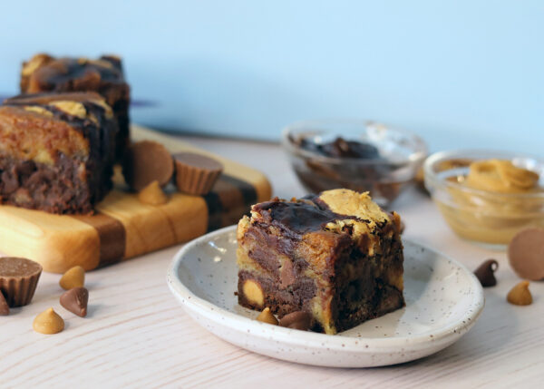 Peanut Buter Cup Brookie on a plate showing swirls of brownie and cookie and chunks of peanut butter cups.