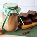 A jar of DIY brownie mix with assorted ingredients and a platter of baked brownies.