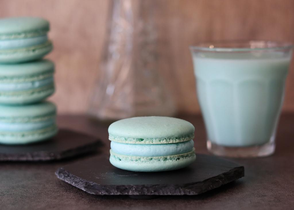 Mandalorian Macarons on hexagon plates with a glass of blue milk