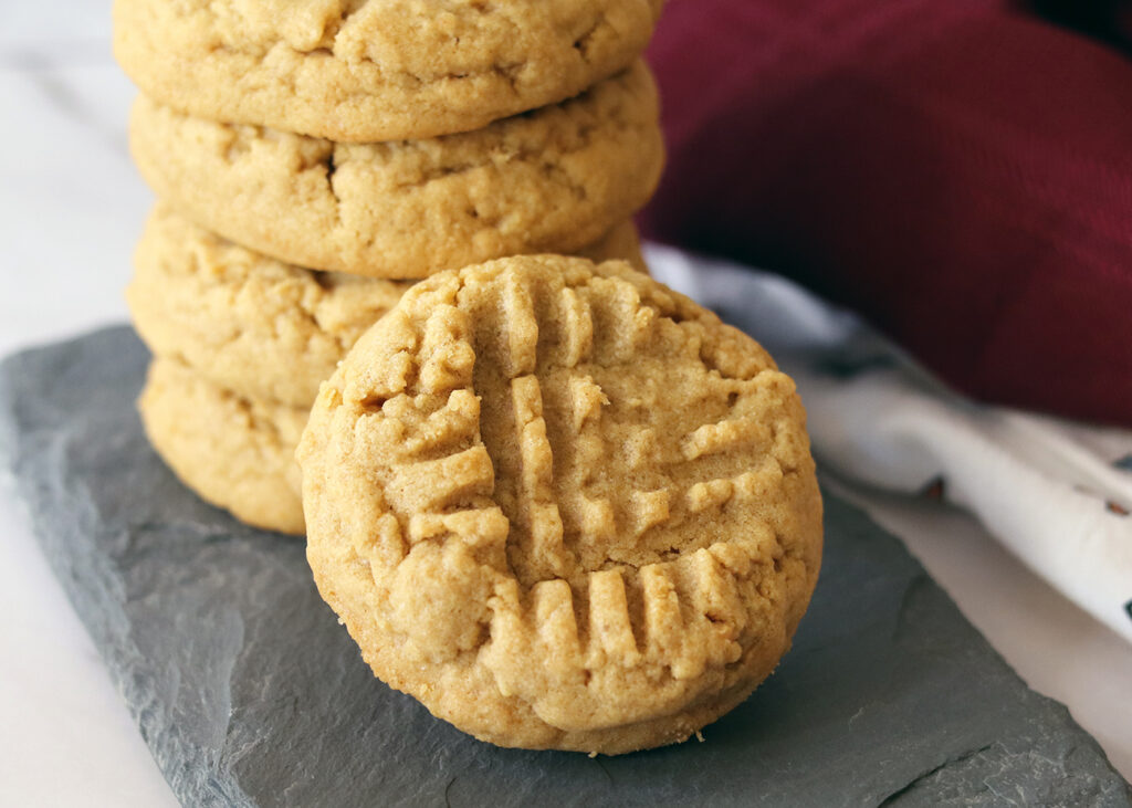 Peanut Butter Cookies stacked up on a slate serving board