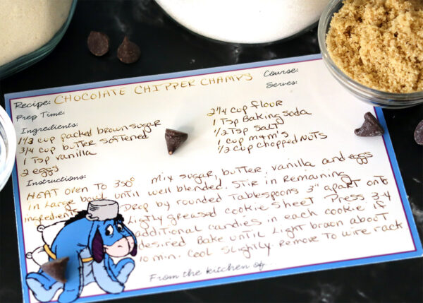 Chocolate Chipper Champs handwritten recipe card and a few ingredients.