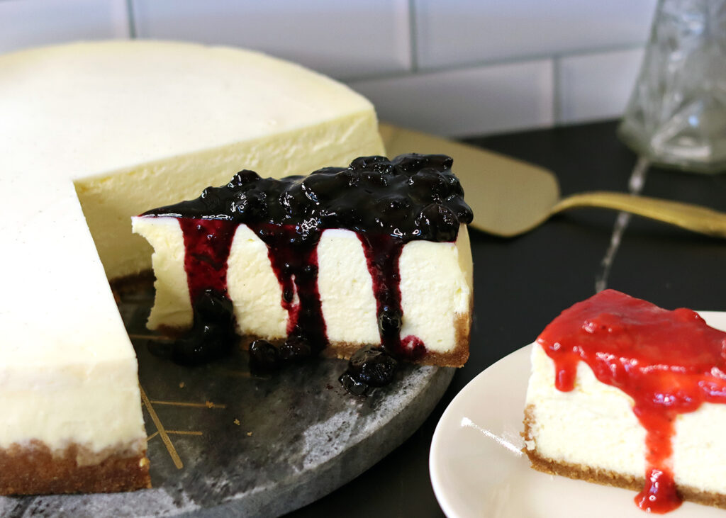 New York Cheesecake slice topped with fresh blueberry sauce