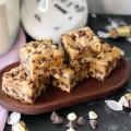 Caramel Chip Bars piled on a small wooden platter