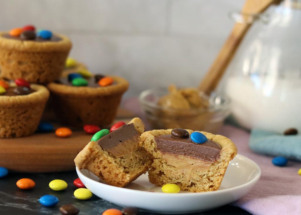 Choco Peanut Butter Cup split open on a small plate. More piled in the background.
