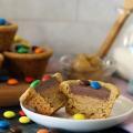 Choco Peanut Butter Cup split open on a small plate. More piled in the background.