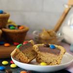 Choco Peanut Butter Cup split open on a small plate. More piled in the background.