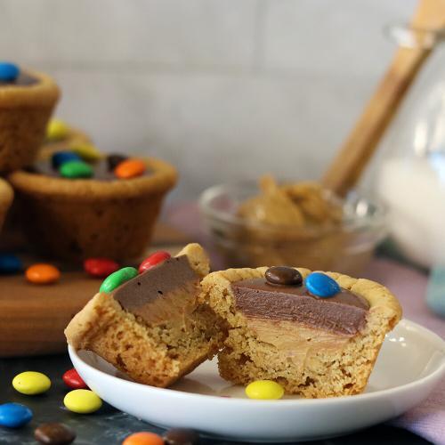 Choco Peanut Butter Cup split open on a small plate. More piled in the background.