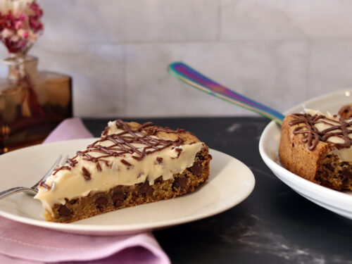 A slice of a Chocolate Chip Cookie Tart on a plate.