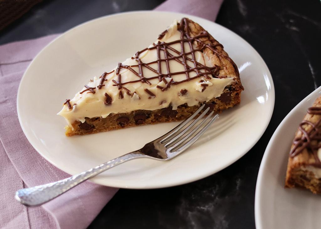 Chocolate Chip Cookie Tart slice on a white plate with a fork