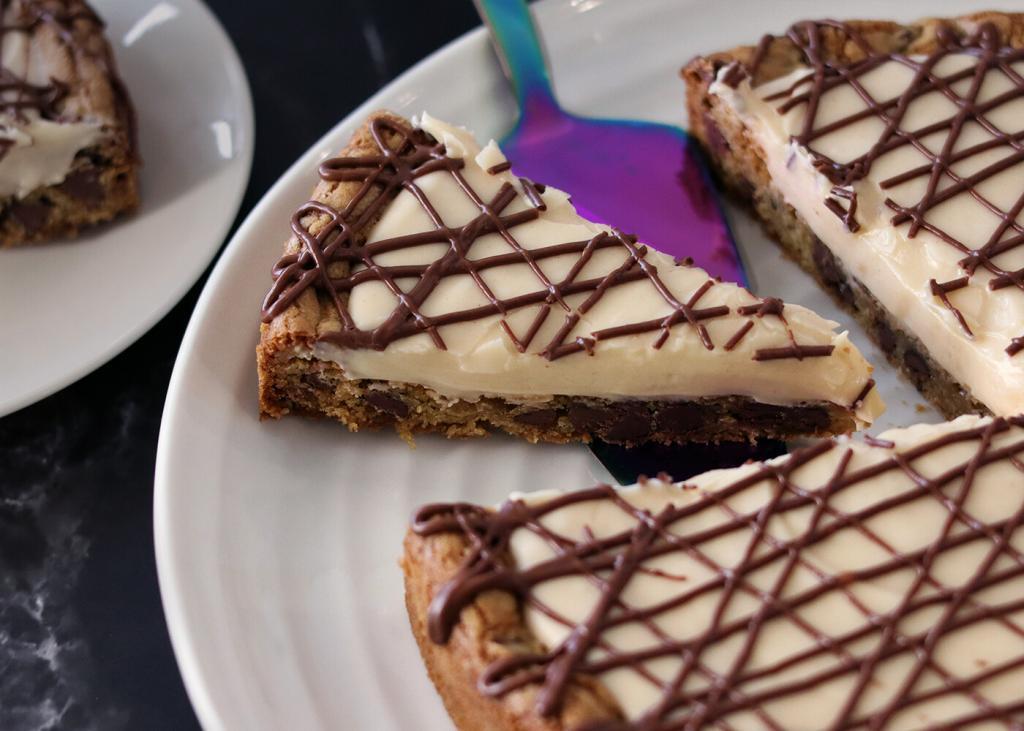 Whole Chocolate Chip Cookie Tart with a slice being served.