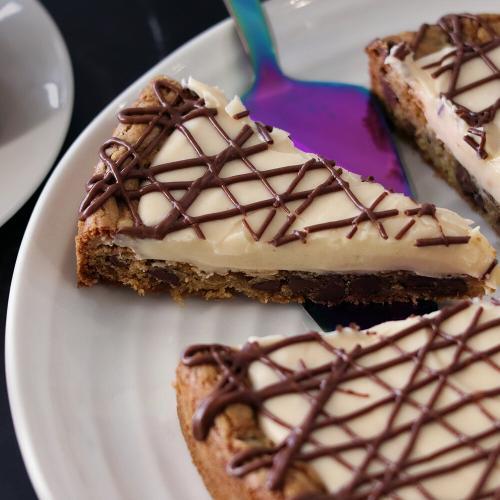 Whole Chocolate Chip Cookie Tart with a slice being served.