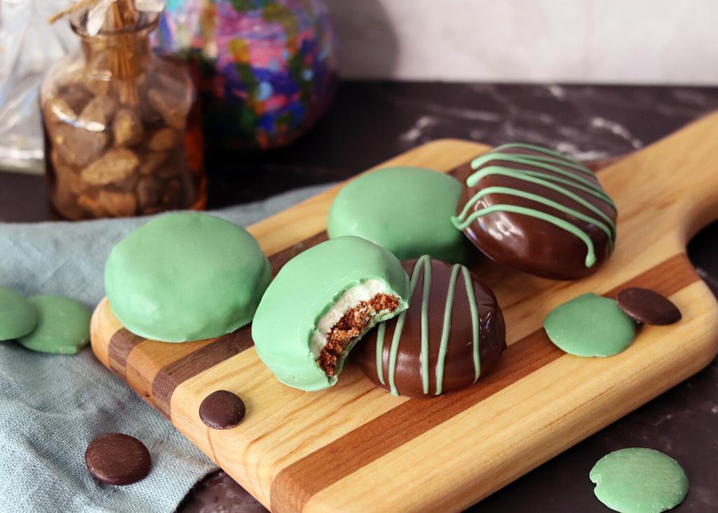 Chocolate Mint Surprises on a wooden board with a bite taken from one.