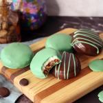 Chocolate Mint Surprises on a wooden board with a bite taken from one.