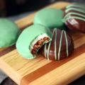 Chocolate Mint Surprises on a wooden board, a bite taken out of one