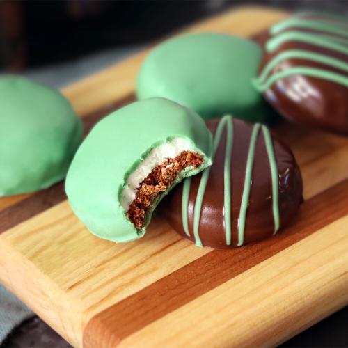 Chocolate Mint Surprises on a wooden board, a bite taken out of one