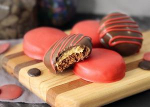 Chocolate Peanut Butter Surprises on a wooden board, a bite taken from one