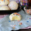 Italian Sprinkle Cookies on a serving platter, one with a bite missing.