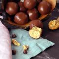 Peanut Butter Balls piled on a serving tray, with one broken open