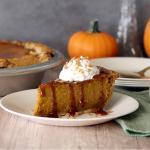 Caramel Toffee Pumpkin Pie topped with whipped cream, caramel and crushed toffee