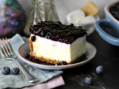 A slice of Mom's Blueberry Cheesecake on a small plate