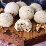 Sugar Coated Melt-Aways on a small wooden serving board with a bite out of one.