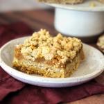 Oatmeal Crumble Pumpkin Pie Bar on a small plate showing the crisp crumble top, pumpkin filling and oat cookie base.