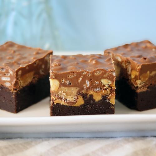 Peanut Butter Crunch Brownies arranged on a white plate.
