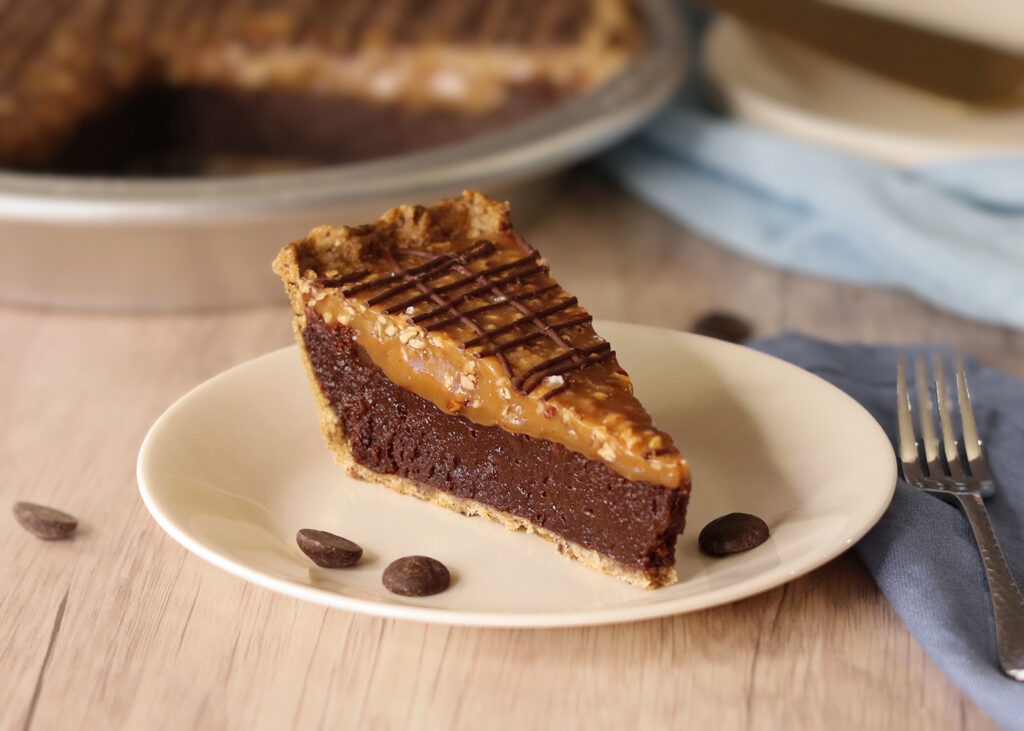 Salted Turtle Fudge Pie slice on a white plate.