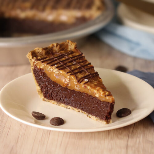 Salted Turtle Fudge Pie slice on a white plate.