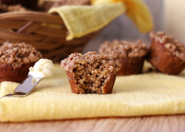 Mini Banana Crumb Muffin with a bite taken out of it.