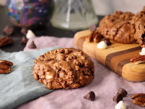 Chocolate Bliss Cookie on napkins in front of a serving board with more cookies.