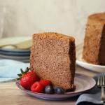 Cocoa Angel Food Cake slice on a plate with berries.