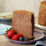 Cocoa Angel Food Cake slice on a plate with berries.