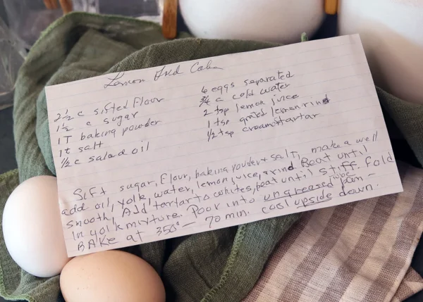 Handwritten Lemon Gold Cake recipe card displayed with some of the ingredients.