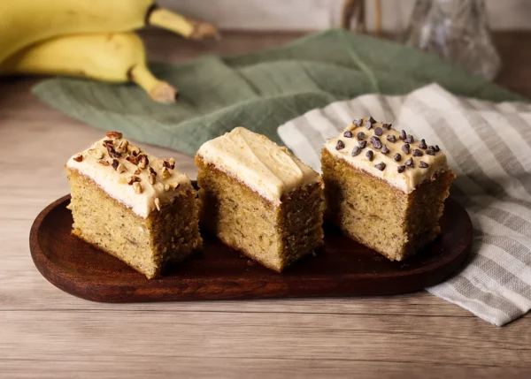 Three pieces of Brown Butter Banana Snack Cake showing alternate topping options.