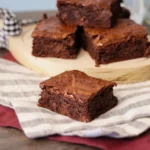 Sourdough Brownie on a linen napkin showcasing the crackly top and fudgy interior.