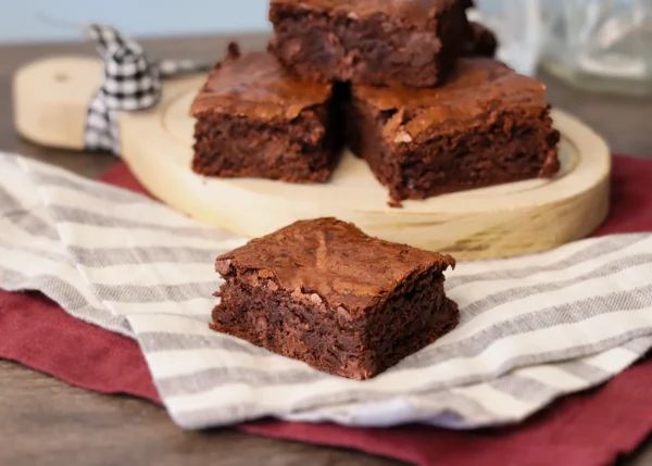 Sourdough Brownie on a linen napkin showcasing the crackly top and fudgy interior.