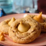 Three Butterbeer blossom cookies arranged on an apricot colored plate.
