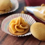 Butterbeer ganache piped onto a wafer cookie.